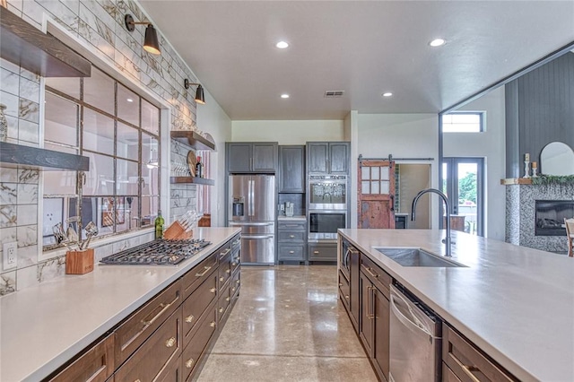 25478 Sooner Ave, Purcell, OK 73080 - kitchen with stainless steel appliances, open shelves, light countertops, concrete floors, and recessed lighting