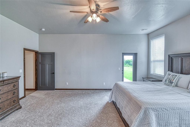25478 Sooner Ave, Purcell, OK 73080 - carpeted bedroom with access to outside and ceiling fan