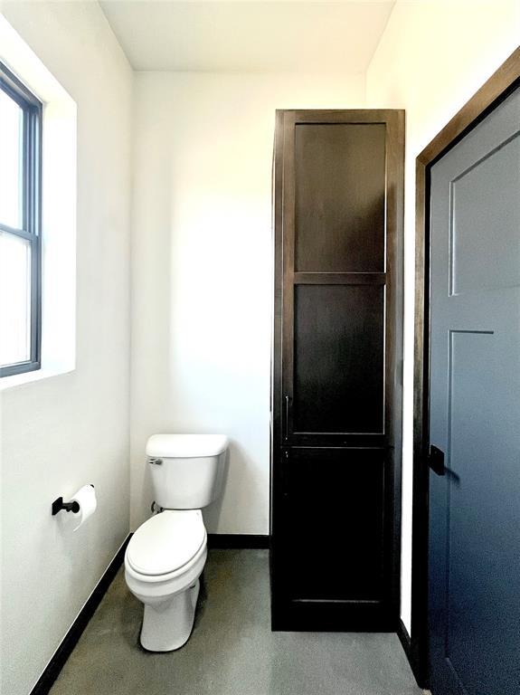 25478 Sooner Ave, Purcell, OK 73080 - bathroom featuring baseboards and toilet