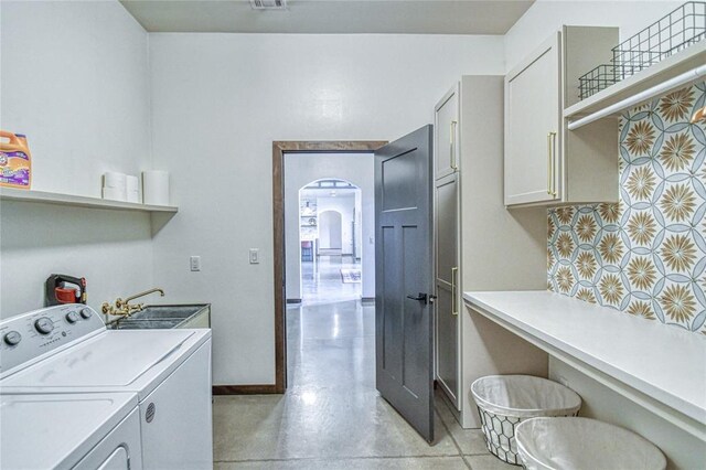 25478 Sooner Ave, Purcell, OK 73080 - washroom featuring cabinet space, washing machine and dryer, and arched walkways