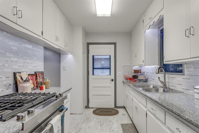 10 Burk Way, Del City, OK 73115 - kitchen with backsplash, stainless steel range with gas cooktop, light countertops, and a sink