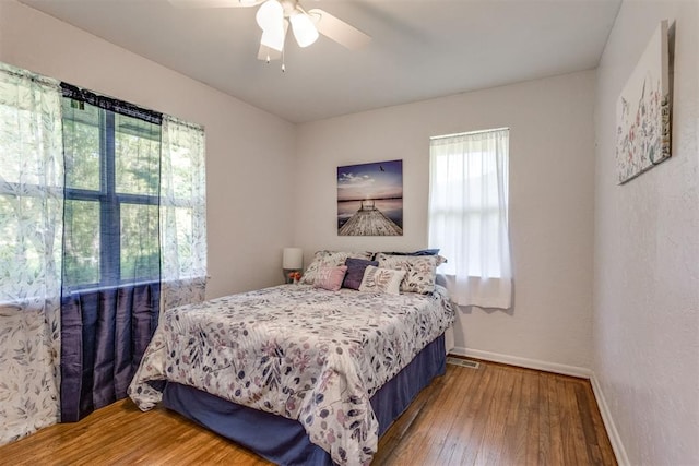 10 Burk Way, Del City, OK 73115 - bedroom with visible vents, hardwood / wood-style flooring, baseboards, and ceiling fan