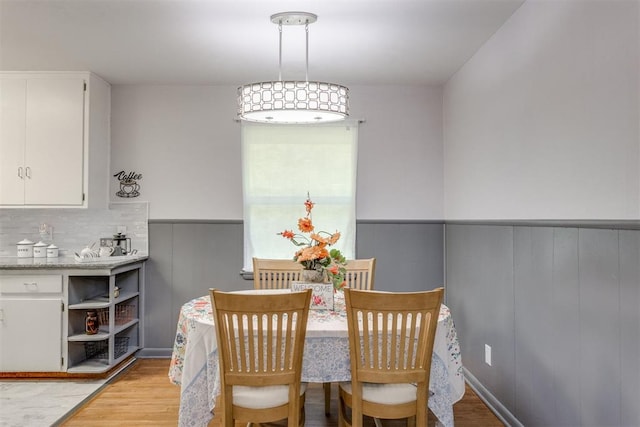 10 Burk Way, Del City, OK 73115 - dining space featuring wainscoting and light wood-style floors