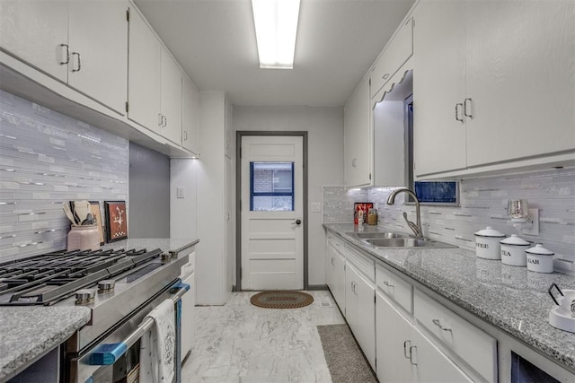 10 Burk Way, Del City, OK 73115 - kitchen featuring marble finish floor, a sink, gas range, and tasteful backsplash