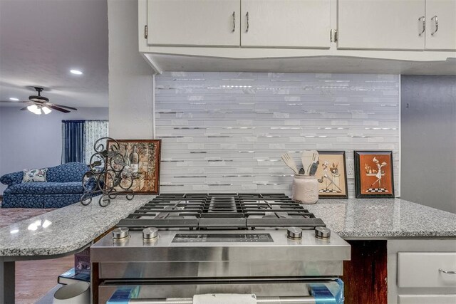 10 Burk Way, Del City, OK 73115 - kitchen with white cabinets, decorative backsplash, a ceiling fan, and recessed lighting