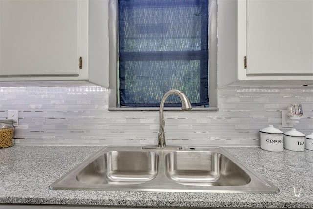 10 Burk Way, Del City, OK 73115 - details with white cabinets, light countertops, a sink, and tasteful backsplash