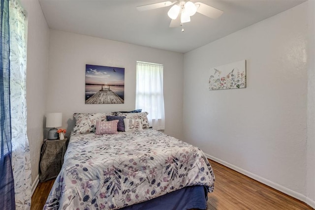 10 Burk Way, Del City, OK 73115 - bedroom featuring baseboards, a ceiling fan, and wood finished floors