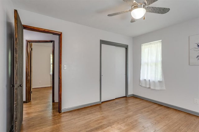 10 Burk Way, Del City, OK 73115 - unfurnished bedroom featuring baseboards, a closet, and light wood-style flooring