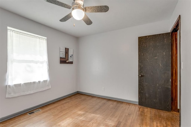 10 Burk Way, Del City, OK 73115 - unfurnished room featuring wood finished floors, visible vents, a ceiling fan, and baseboards