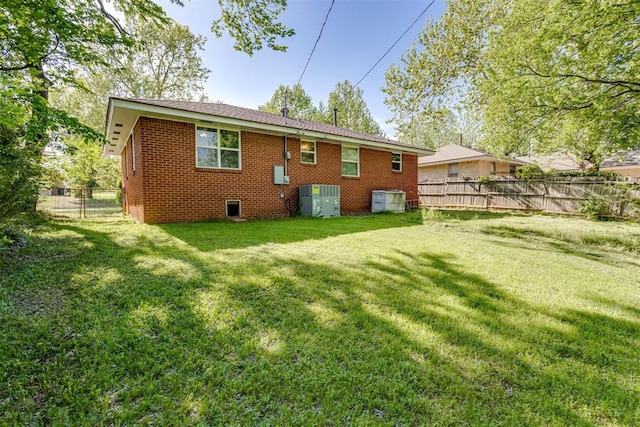 10 Burk Way, Del City, OK 73115 - back of house with a lawn, fence, crawl space, and brick siding
