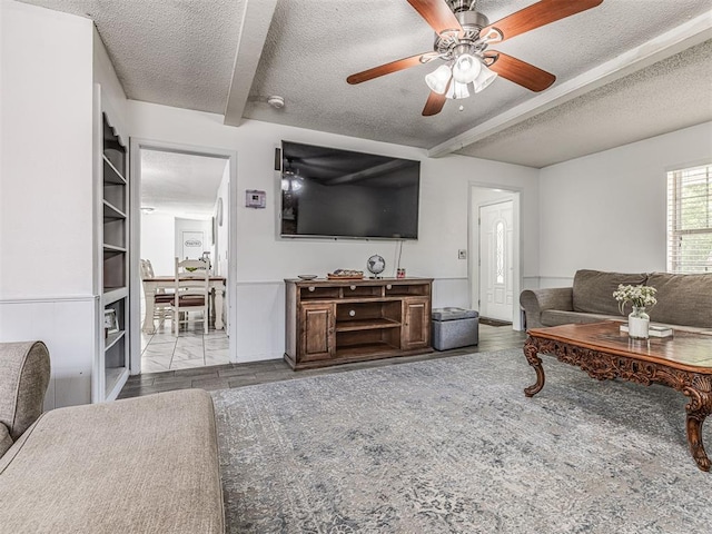 2909 Wheeler Ct, Oklahoma City, OK 73127 - living room featuring a ceiling fan, wood finished floors, and a textured ceiling