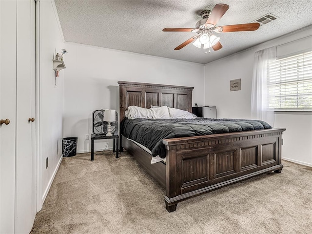 2909 Wheeler Ct, Oklahoma City, OK 73127 - bedroom featuring a textured ceiling, visible vents, a ceiling fan, and light carpet
