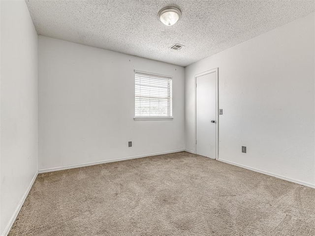 2909 Wheeler Ct, Oklahoma City, OK 73127 - carpeted spare room featuring a textured ceiling, visible vents, and baseboards