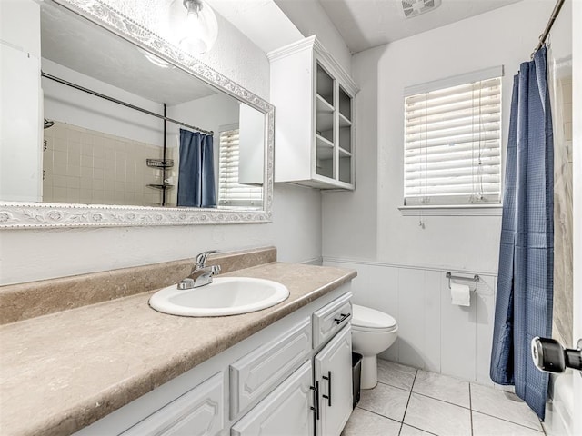 2909 Wheeler Ct, Oklahoma City, OK 73127 - full bath with tile patterned floors, a wainscoted wall, toilet, visible vents, and vanity