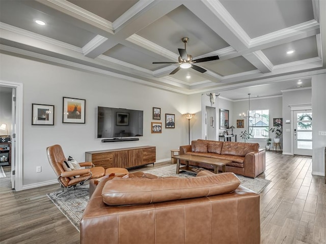 living area featuring baseboards, ornamental molding, and wood finished floors