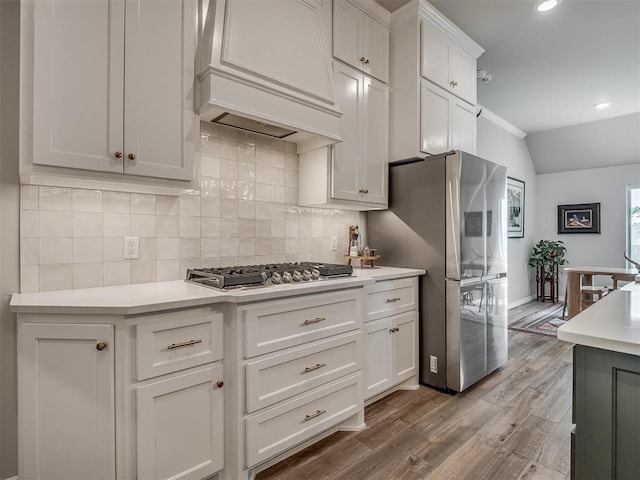 kitchen featuring white cabinets, appliances with stainless steel finishes, light countertops, recessed lighting, and decorative backsplash