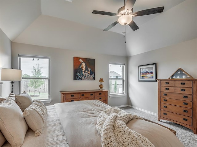 bedroom featuring light colored carpet, baseboards, vaulted ceiling, and ceiling fan