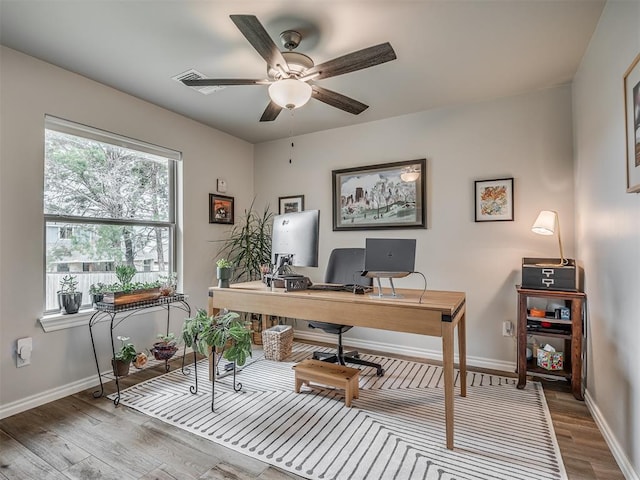 office featuring baseboards, ceiling fan, and wood finished floors