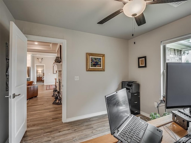 office featuring baseboards, ceiling fan, and wood finished floors