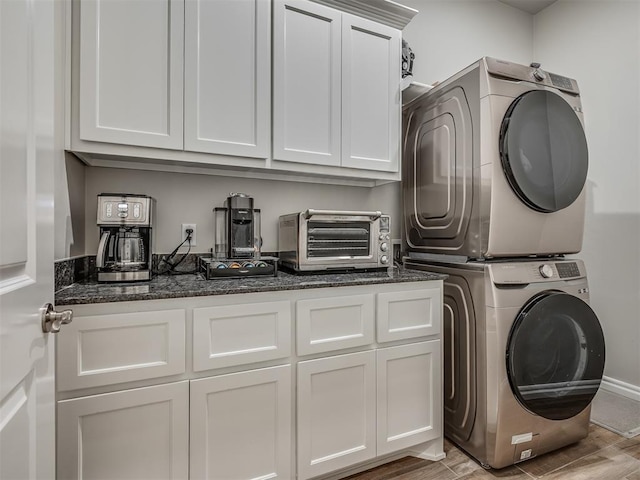 laundry room with stacked washer / dryer, light wood finished floors, and a toaster
