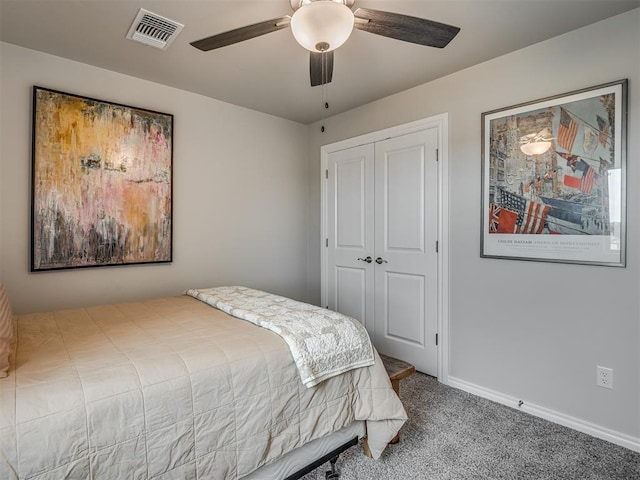 bedroom with visible vents, a ceiling fan, a closet, baseboards, and carpet flooring