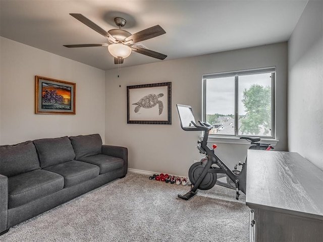 exercise area featuring baseboards, ceiling fan, and carpet flooring