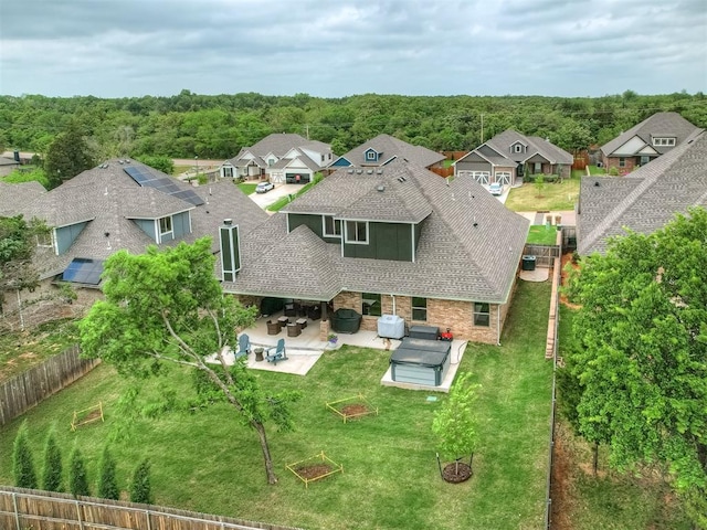 drone / aerial view with a view of trees and a residential view