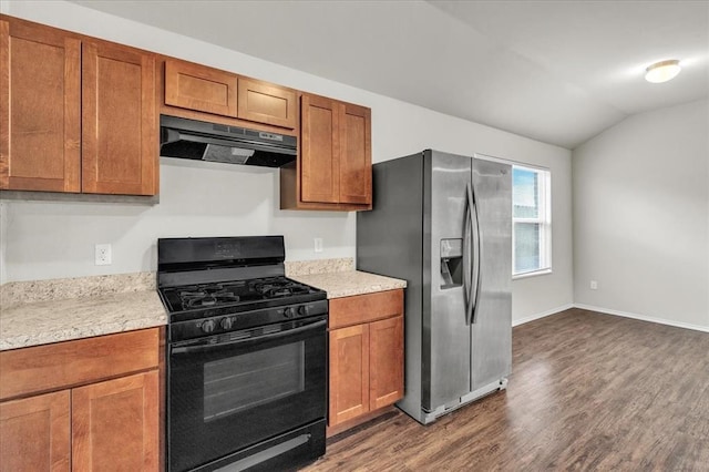 kitchen featuring dark wood-style floors, under cabinet range hood, black gas stove, stainless steel refrigerator with ice dispenser, and vaulted ceiling