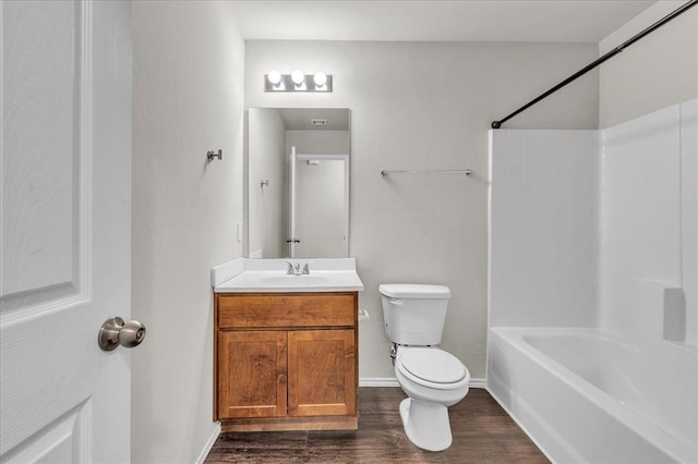 bathroom featuring tub / shower combination, wood finished floors, toilet, and vanity