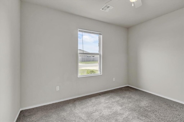 empty room with visible vents, carpet, and baseboards