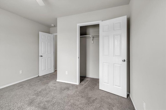 unfurnished bedroom featuring baseboards, a closet, and carpet flooring