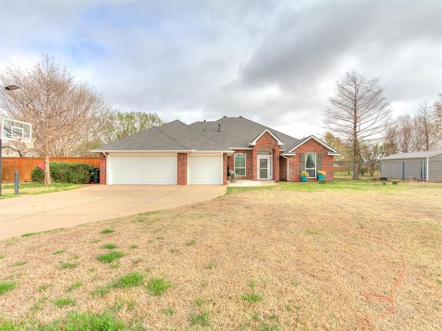 ranch-style home with brick siding, fence, driveway, and a garage