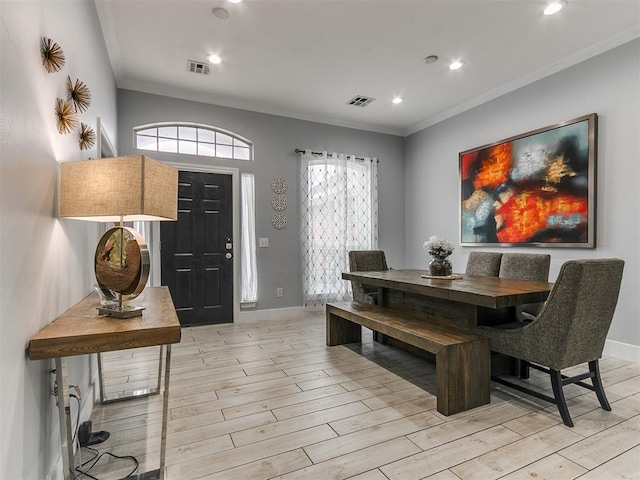 dining area with ornamental molding, light wood finished floors, visible vents, and recessed lighting