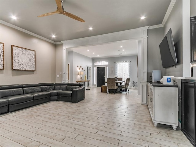 living room with recessed lighting, crown molding, light wood-type flooring, and a ceiling fan