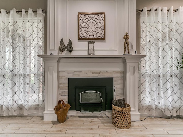 details featuring wood finished floors and a fireplace