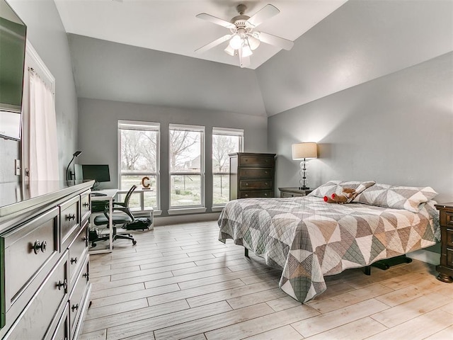 bedroom featuring lofted ceiling, a ceiling fan, and light wood finished floors