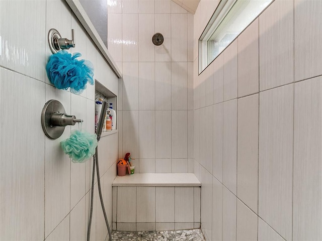 bathroom featuring tile walls and tiled shower