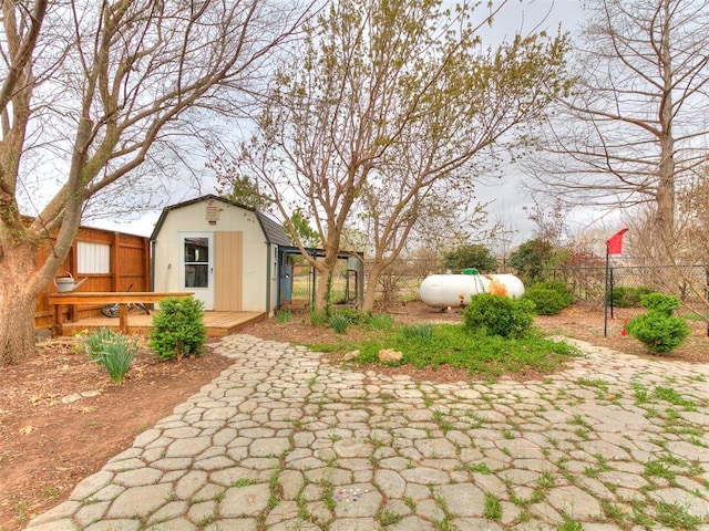 view of yard with fence, an outbuilding, and a storage shed