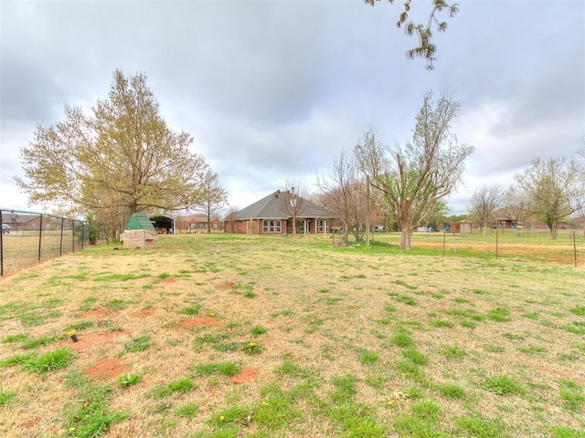 view of yard with an outbuilding and fence