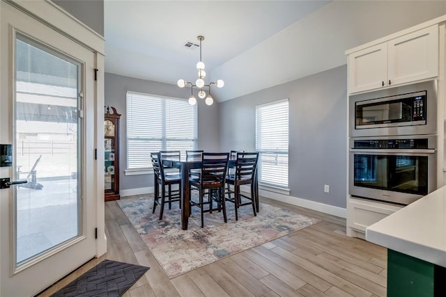 4145 Thunderhead Rd, Norman, OK 73072 - dining space with a chandelier, light wood-style flooring, plenty of natural light, and vaulted ceiling