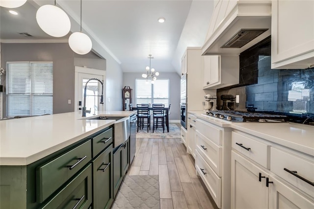 4145 Thunderhead Rd, Norman, OK 73072 - kitchen featuring green cabinetry, premium range hood, stainless steel appliances, light countertops, and white cabinets