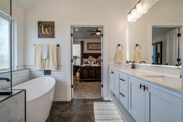 4145 Thunderhead Rd, Norman, OK 73072 - full bath featuring a freestanding bath, double vanity, a ceiling fan, ensuite bathroom, and vaulted ceiling