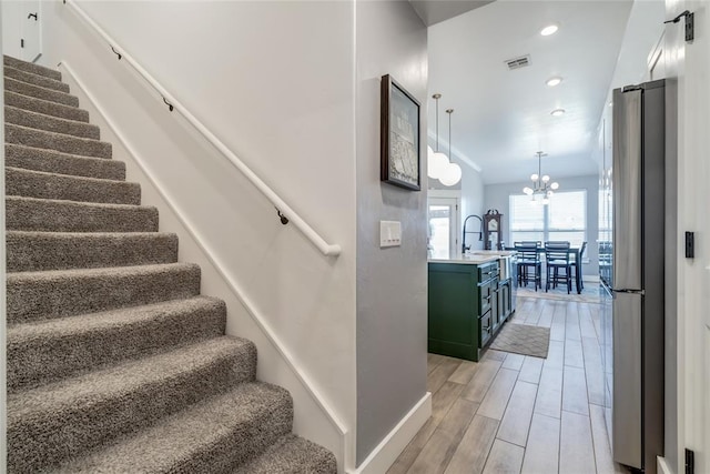 4145 Thunderhead Rd, Norman, OK 73072 - staircase with a chandelier, wood finished floors, and recessed lighting