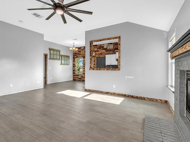 12506 SE 16th Ct, Choctaw, OK 73020 - unfurnished living room with a fireplace, ceiling fan, a chandelier, wood finished floors, and lofted ceiling