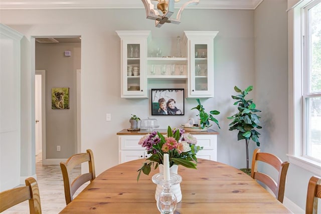 8350 Red Feather, Arcadia, OK 73007 - dining space with baseboards, wood finished floors, a wealth of natural light, and a notable chandelier