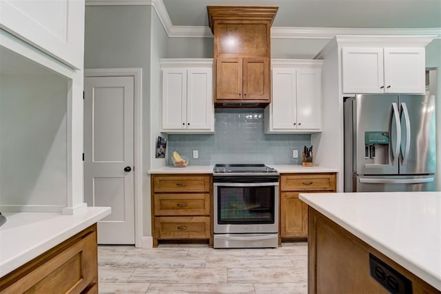 8350 Red Feather, Arcadia, OK 73007 - kitchen with white cabinets, stainless steel appliances, light countertops, and ornamental molding