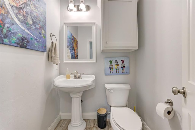 8350 Red Feather, Arcadia, OK 73007 - half bath featuring baseboards, toilet, and wood finished floors