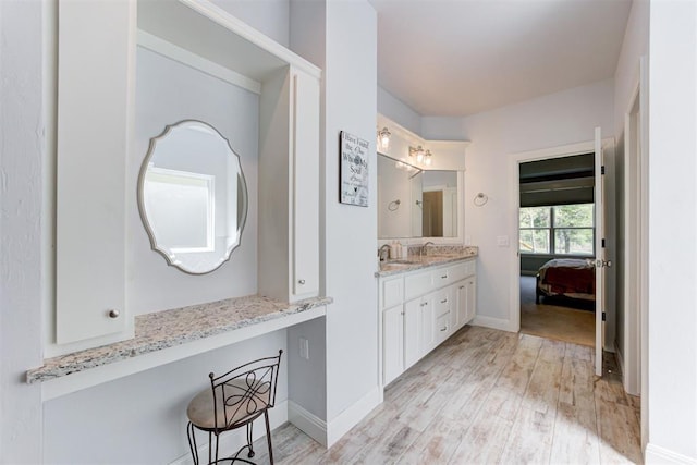 8350 Red Feather, Arcadia, OK 73007 - bathroom featuring baseboards, wood finished floors, vanity, and ensuite bathroom