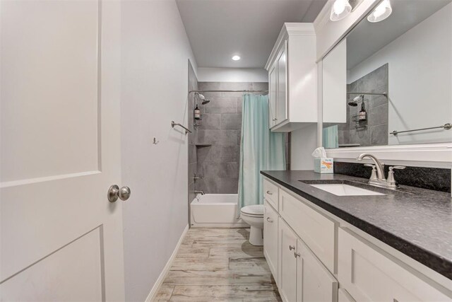 8350 Red Feather, Arcadia, OK 73007 - full bath with toilet, baseboards, wood finished floors, shower / bathtub combination with curtain, and vanity