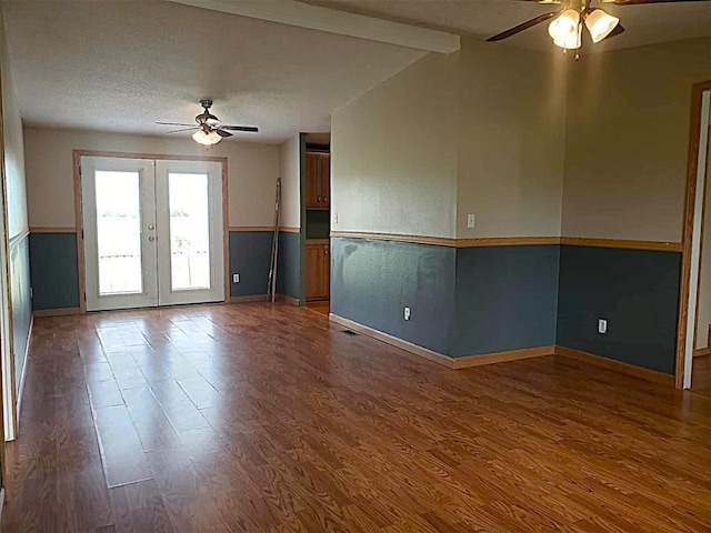 spare room featuring baseboards, ceiling fan, french doors, and wood finished floors